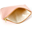 A cream striped interior with a gold zipper on a pink design zip pouch named after Lakota