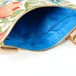 A bright blue interior on a floral crossbody bag named after Leanna.