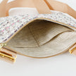 A neutral fabric interior on a tweed multi-color crossbody named after Lydia