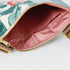 A pink interior of a multi-panel flower crossbody pouch named after Nadiya 