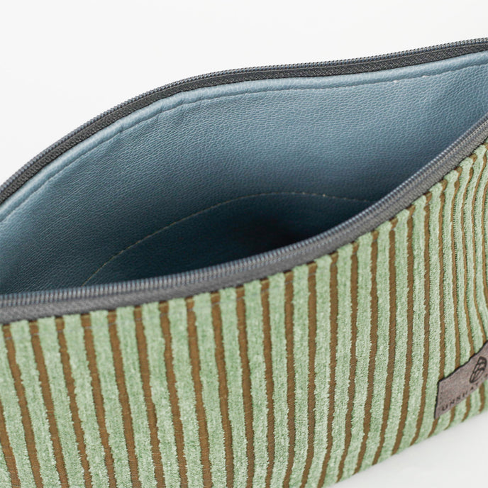 Green striped makeup kit open to show blue luxury leather alternative interior