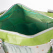 Close-up of a green transparent interior with silver zipper on a white background named after Caitlyn 