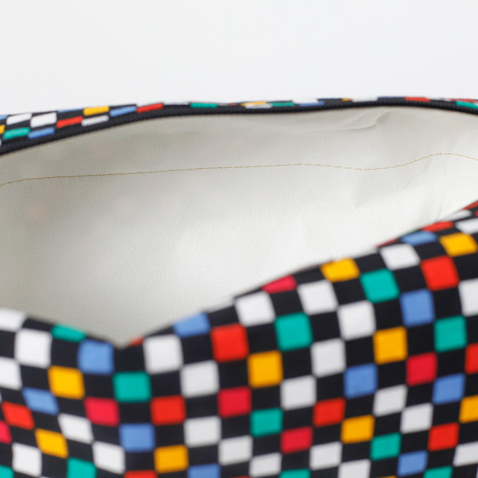 Close-up of a colorful checkered pattern with white wipe-clean interior on a white background named after Lyddin 