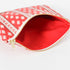 Red interior  with red and white pattern and gold zipper on a white background named after Neena 