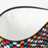 Close-up of a white wipe-clean interior makeup bag with checkered pattern on a white background named after Luisa 