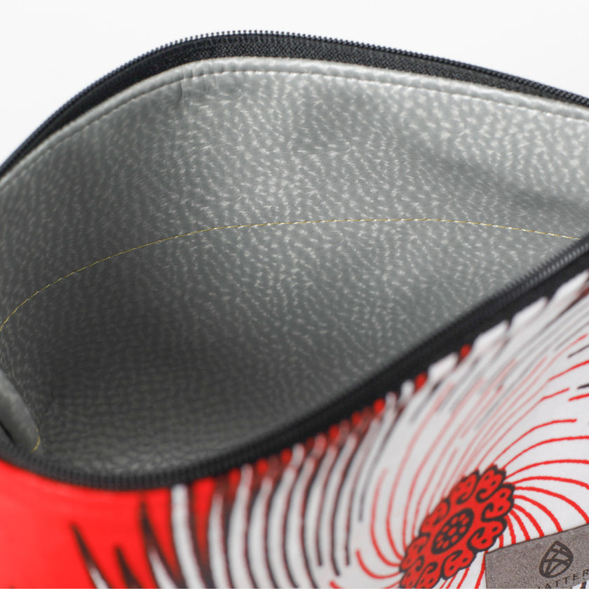 Close-up of a silver wipe-clean interior with a red and white design on a white background named after Marie 