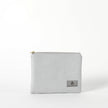 A gray Irene Zip Pouch with a subtle geometric pattern, gold-tone hardware, and a zip closure. The brand's logo is visible on the front.