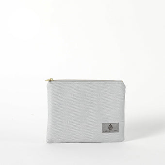 A gray Irene Zip Pouch with a subtle geometric pattern, gold-tone hardware, and a zip closure. The brand's logo is visible on the front.