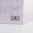 Light purple  textured bag with 'Unshattered' brand label on a white background named after Jaimilee