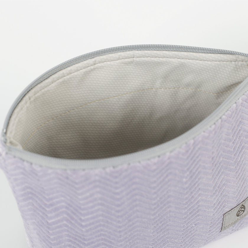 Close-up of a light gray interior  with a zipper on a white background named after Jamar