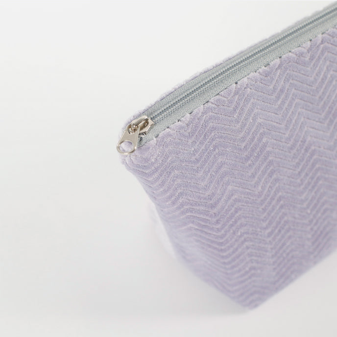 Light Purple Textured makeup with a gray zipper on a white background named after Jamar