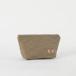A beige makeup kit bag with a textured surface and a zip closure.