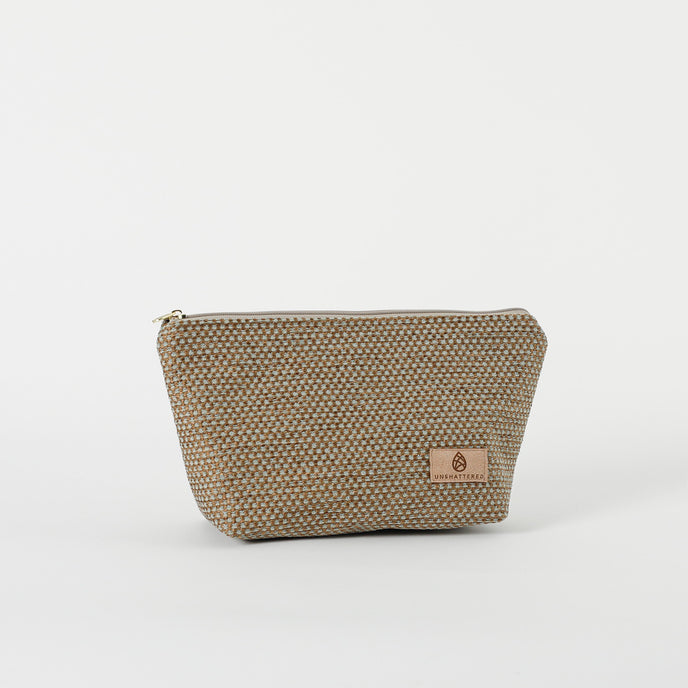 A beige makeup kit bag with a textured surface and a zip closure.