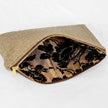 A gold and black floral design interior on this beige design large zip pouch 