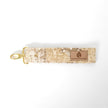 Fabric key clip with a gold clasp on a white background named after Janette