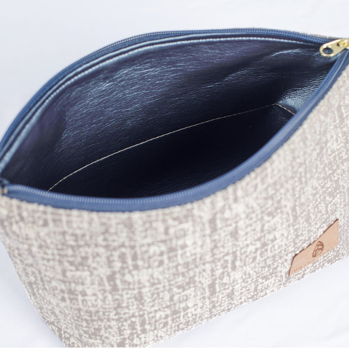 A shiny blue luxury leather alternative interior on this neutral fabric exterior with a gold tone zipper
