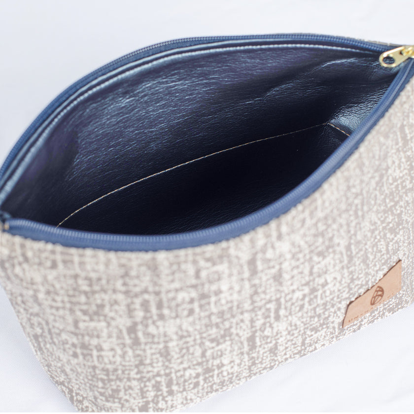 A shiny blue luxury leather alternative interior on this neutral fabric exterior with a gold tone zipper
