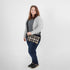 Woman holding a  plaid clutch against a white background named after Jenny