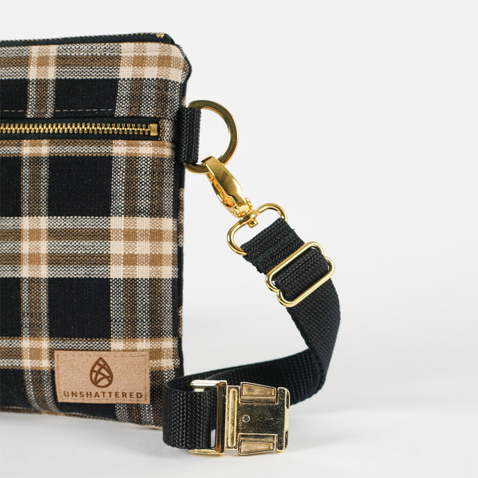 Plaid bag with black strap and gold hardware on a white background named after Jenny