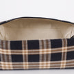 Close-up of a plaid fabric toiletry bag with beige lining on a white background named after Jeremiah 