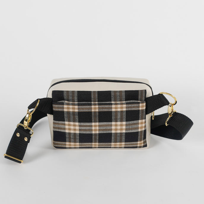 Black and beige plaid errand bag with gold accents on a light gray background named after Jesus