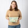 A woman holding a Cosmetic bag with floral pattern named after Jill 