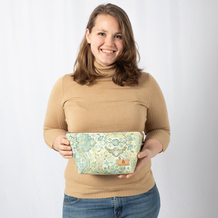A woman holding a Cosmetic bag with floral pattern named after Jill 