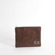 Brown suede pouch with a brand logo on a white background