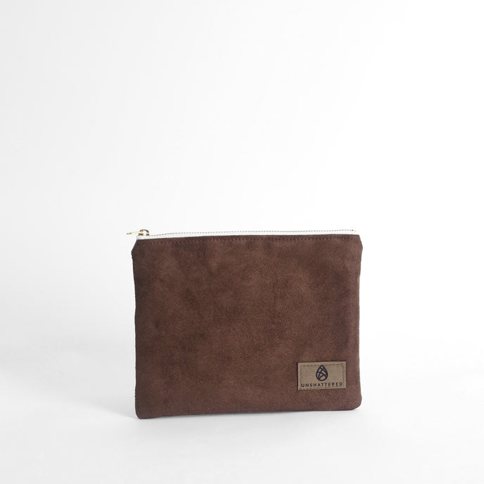 Brown suede pouch with a brand logo on a white background