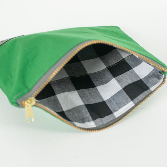 A black and white checkered fabric with a gold seam on the interior. 