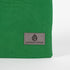 A gray Unshattered label on this green zip pouch 