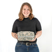 Person holding a camouflage-patterned bag against a white background