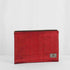 A red large zip pouch with gold-tone hardware, made from upcycled materials, with a brand tag displaying Unshattered