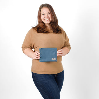 Woman holding a blue pouch against a white background named after Karina 