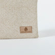A tan label on a beige zip pouch 