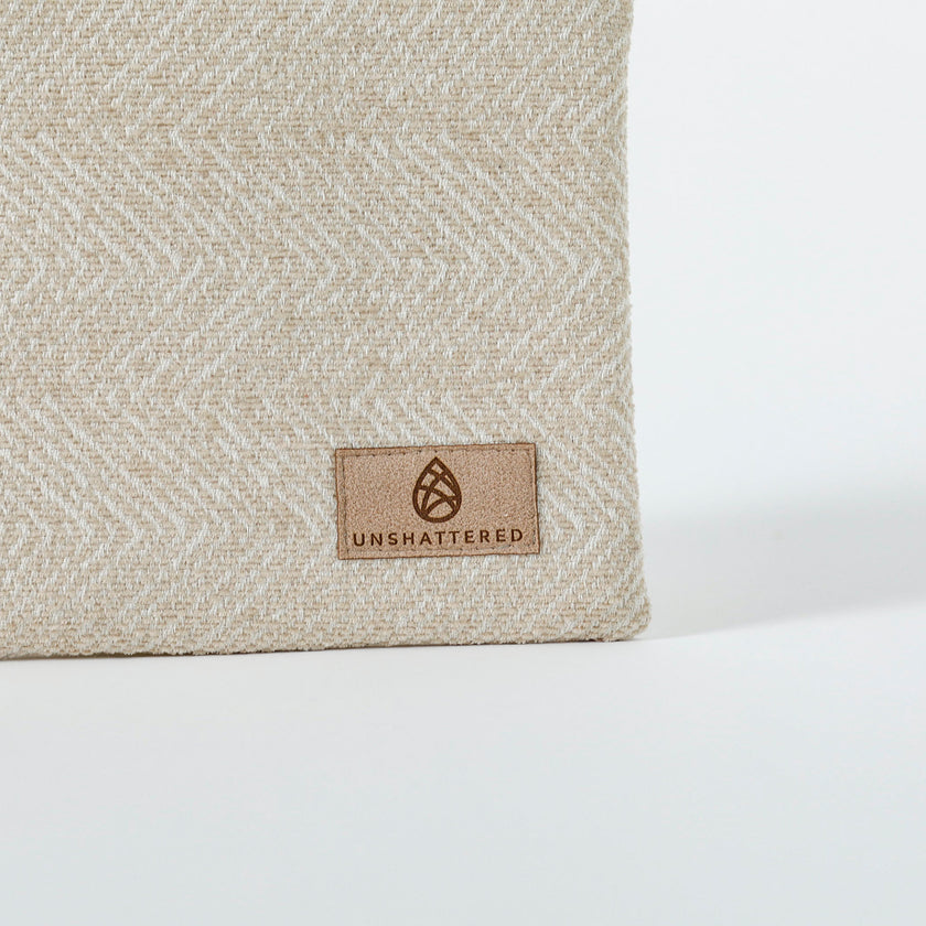 A tan label on a beige zip pouch 