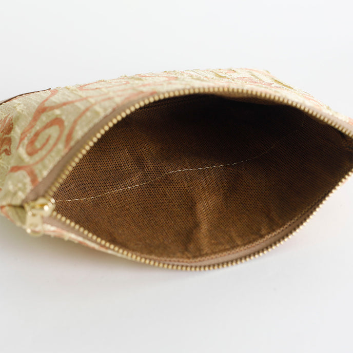 Brown interior shot of gold and orange shimmery zip pouch named after Katima