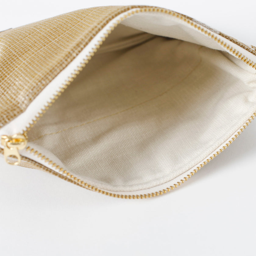 Open beige pouch with gold zipper on a white background