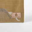 Textured beige zip pouch with 'Unshattered' logo on a white background