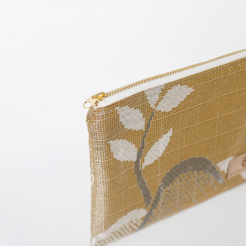 Gold pouch with leaf pattern on a white background named after Kelsey 