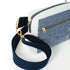 Close up of a gold zipper on a crossbody bag with a blue velvet exterior and blue cotton straps named after Kenya.