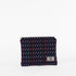 A dark blue zip pouch with a vibrant pattern of colorful short lines, featuring a zip closure and a label with a brand logo named after Keri