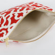 A taupe wipe-clean interior on a red and white design zip pouch 