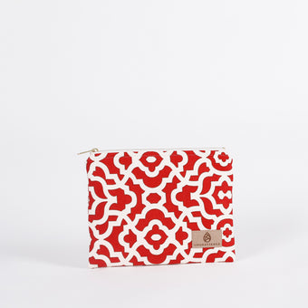 A red and white design fabric zip pouch with a tan label and gold tone hardware