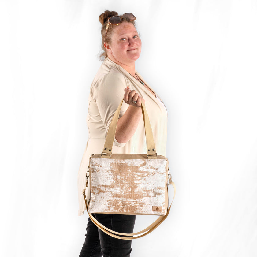 Woman holding a beige handbag with a white background named after Kevin 