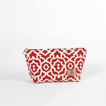 A red and white design makeup kit with a tan label and gold tone zipper on a white background named after Keyrah