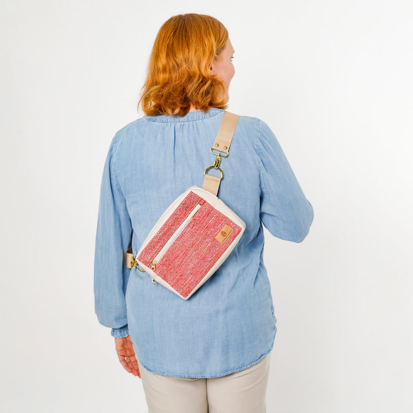 Person wearing a pink and white errand bag on a plain background named after Korin 