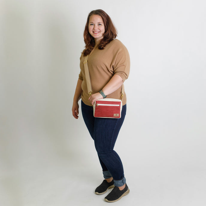 Woman holding a red errand bag against a plain background named after Korin 