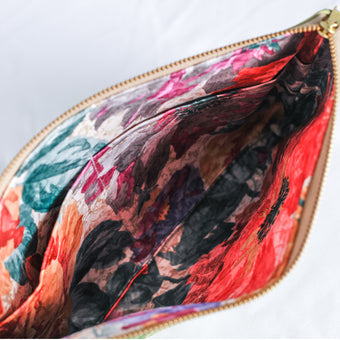 A flower interior fabric with gold seam on a large zip pouch 