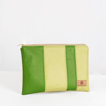 A green multi-panel zip pouch with a visible brand tag showing on the lower right corner, with a zip closure and gold-tone hardware named after Krista.